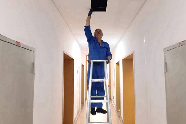 圖為物業(yè)人員利用節(jié)假日對值班宿舍電纜廊道、空調管道進行檢查和維護